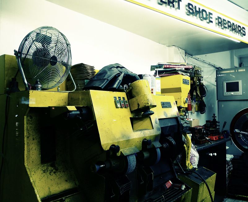 A photo of a big shoe repair machine in one of those shops that repairs shoes and cuts keys